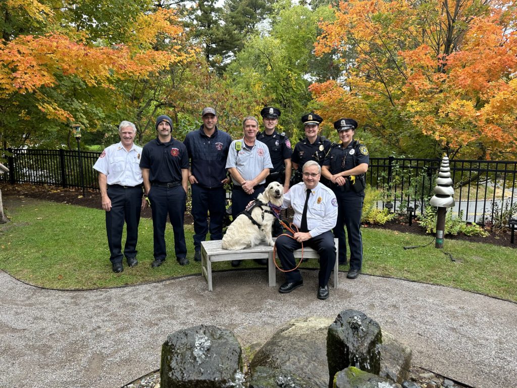 A collection of Wellesley's first responders, firefighters and police officers gathered for a photo near one of the benches in the garden.