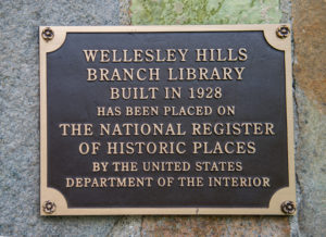 The plaque designating the Hills Branch building for the National Register of Historic Places. The plaque reads: Wellesley Hills branch Library, built in 1928, has been placed on the National Register of Historic Places by the United States Department of the Interior.