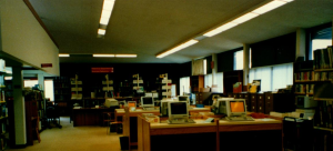 Several computer stations at public desks.