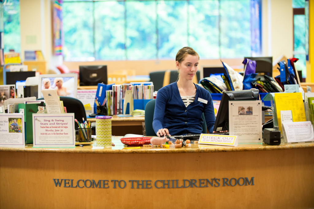A librarian working at the children's desk.