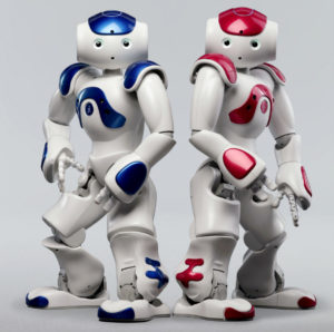 A promotional photo of two humanoid robots- one red and one blue.