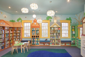 A bright and cheery interior view of the Fells branch library.