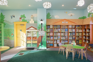 The Wellesley-themed mural and complementary bookshelves in the Fells Branch.