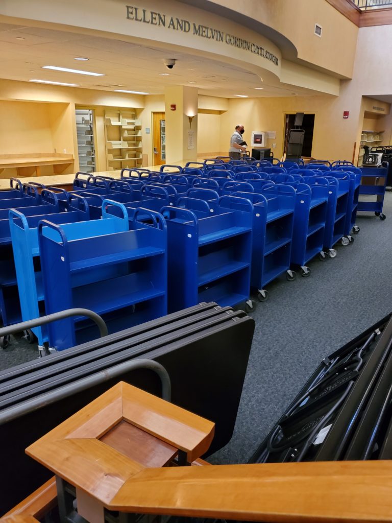 The area that would become the Welcome Center populated with many many blue book carts.