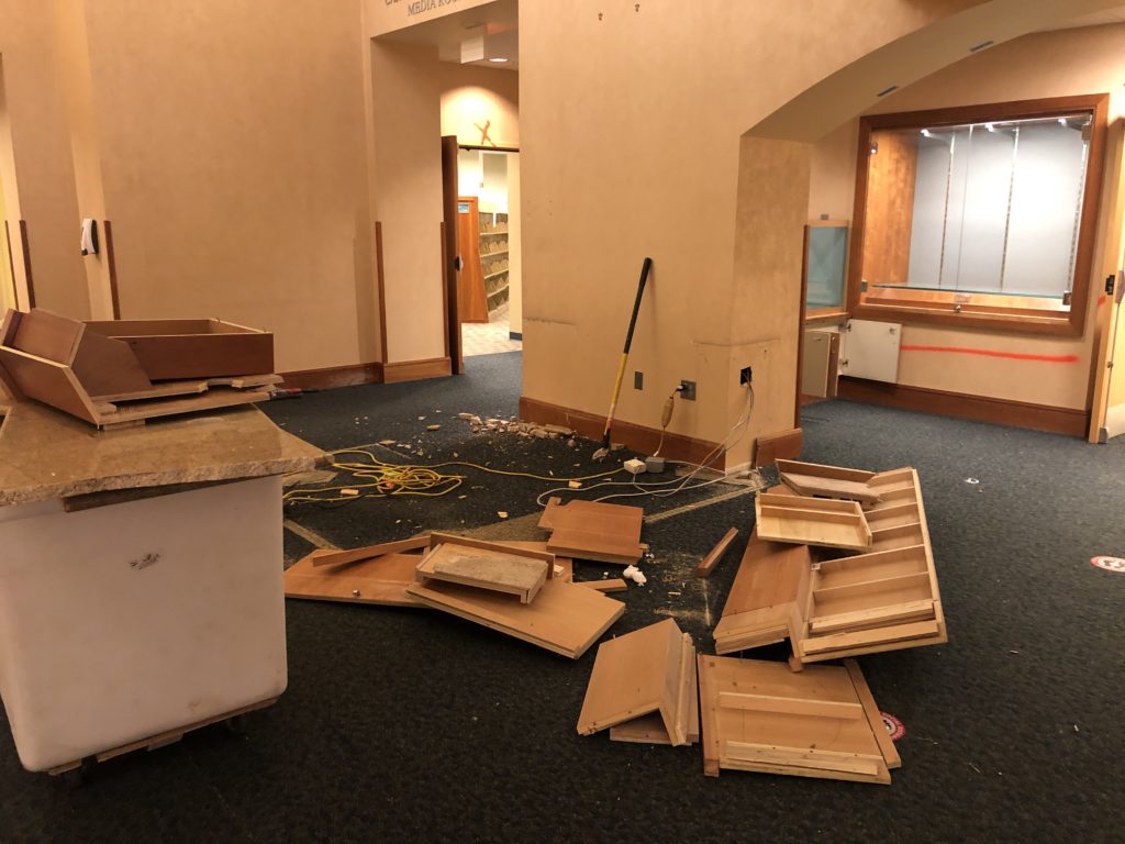 The first floor information desk in pieces. The granite countertop, also in pieces, is sitting on some sort of dolly.