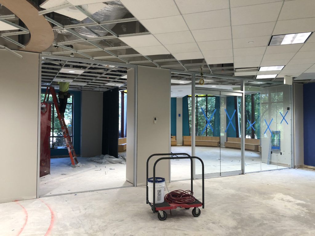 The Craft and Story Time rooms with a new set of tall, glass doors, and a bright new blue paint job. There's still the carpet and ceiling to be installed.