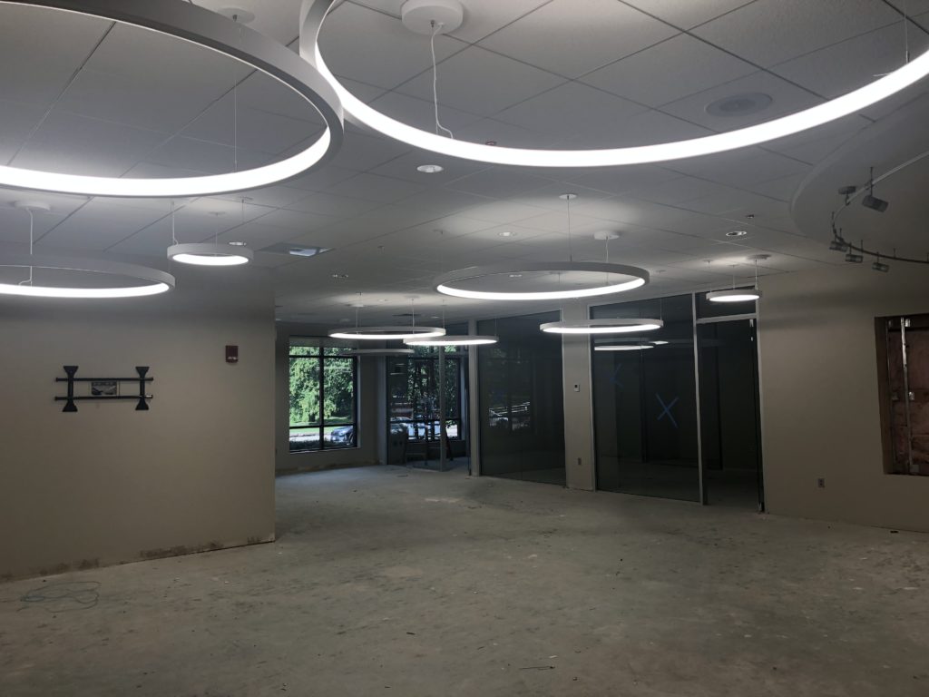 The Commons room with its new hoop-shaped light fixtures. The floor is still unfinished and the meeting rooms in the Commons haven't been outfitted yet.