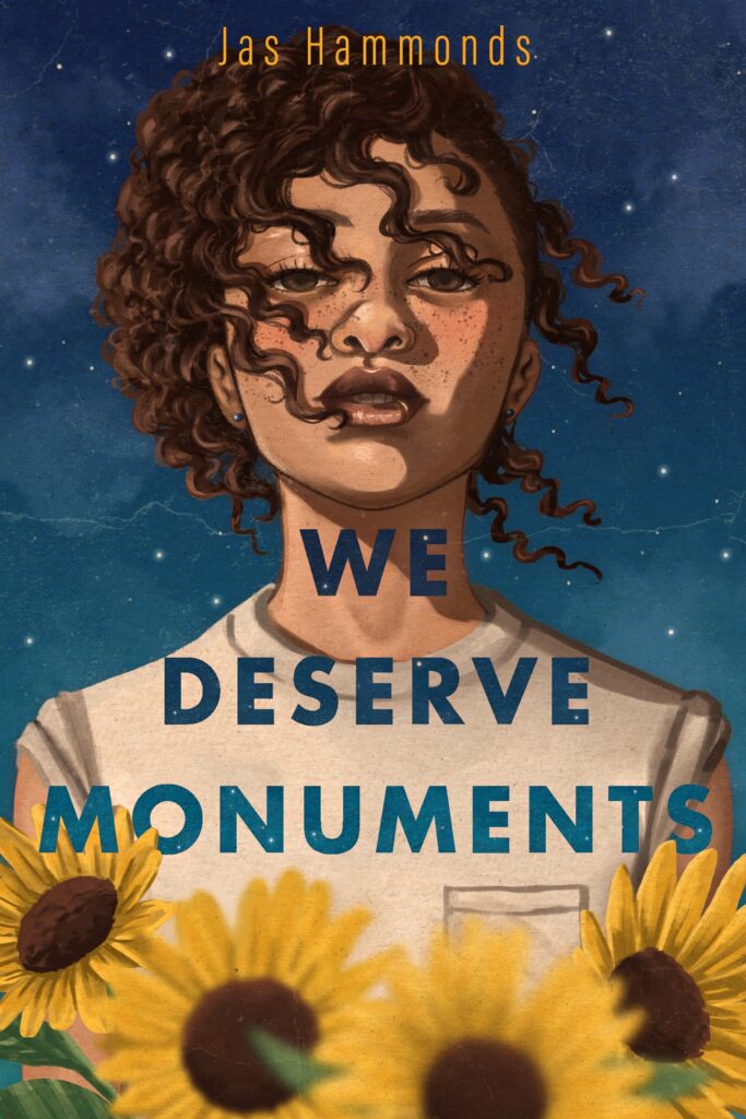 cover of "we deserve monuments," with a person looking out across sunflowers at the viewer, curly hair wind-blown across their face