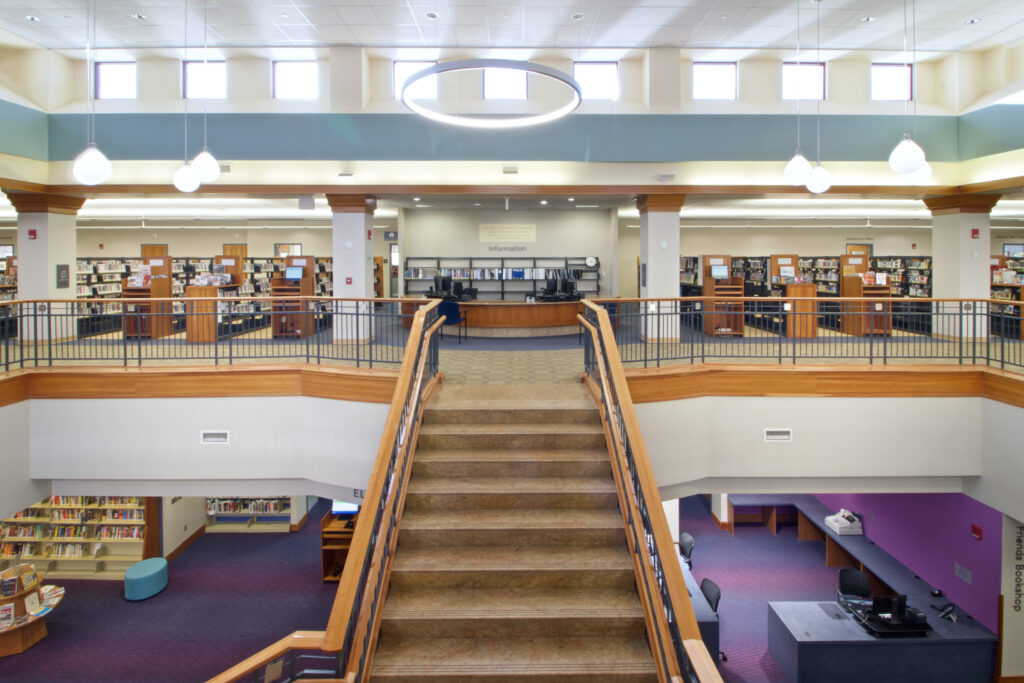 The second floor Information desk from across the room. There is a lot of light in the area from the windows and the new hoop fixtures.