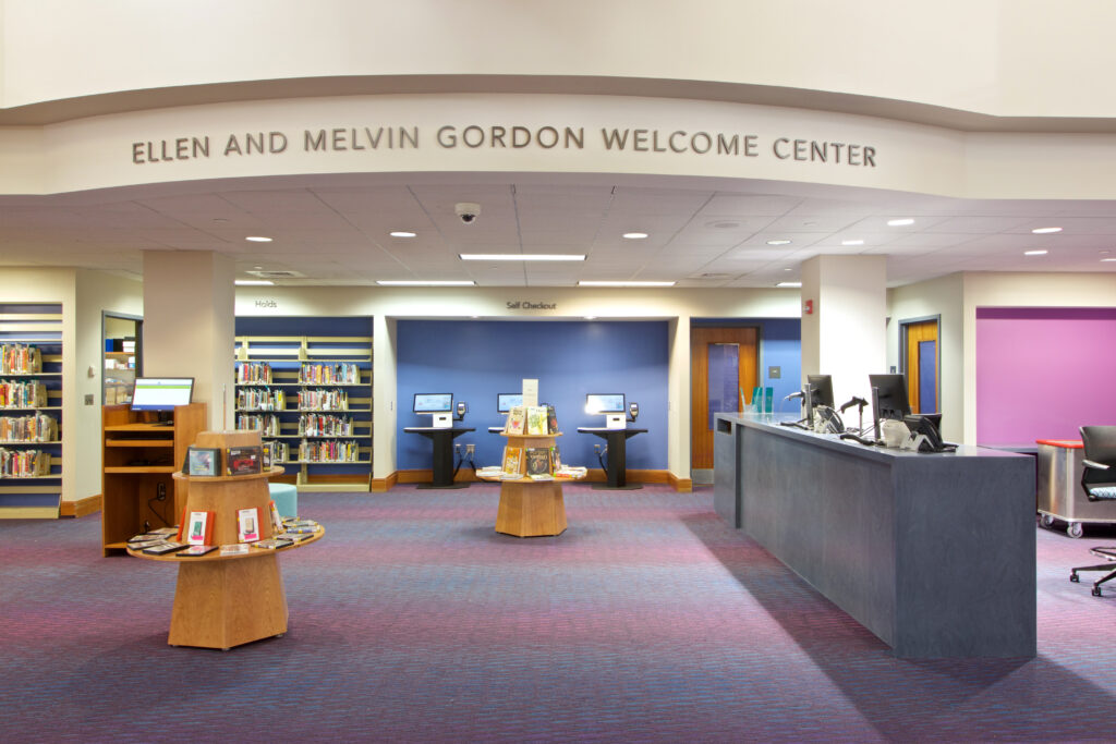 The spacious new Welcome Center. The Welcome Desk is smaller than the circulation desk used to be, allowing more room for patrons to move around and for book and item displays.