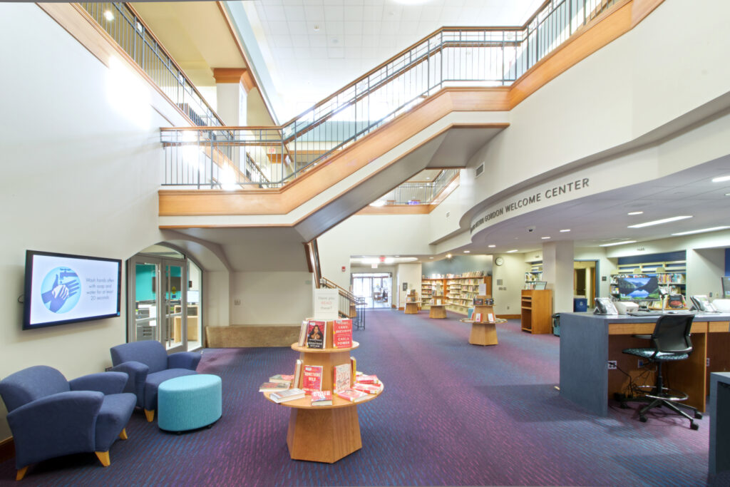 Another view of the Welcome Center, showing the staircase to the second floor, the entrance to Children's, and the book displays in the area. The parking lot entrance is even visible from this photo.