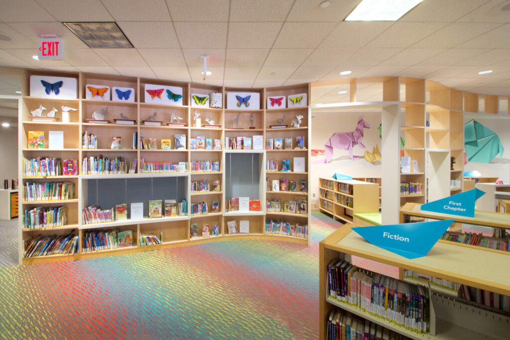 The new Children's Room display area. Along with new materials, the wall holds origami artworks, and a whole series of origami butterflies in different colors.