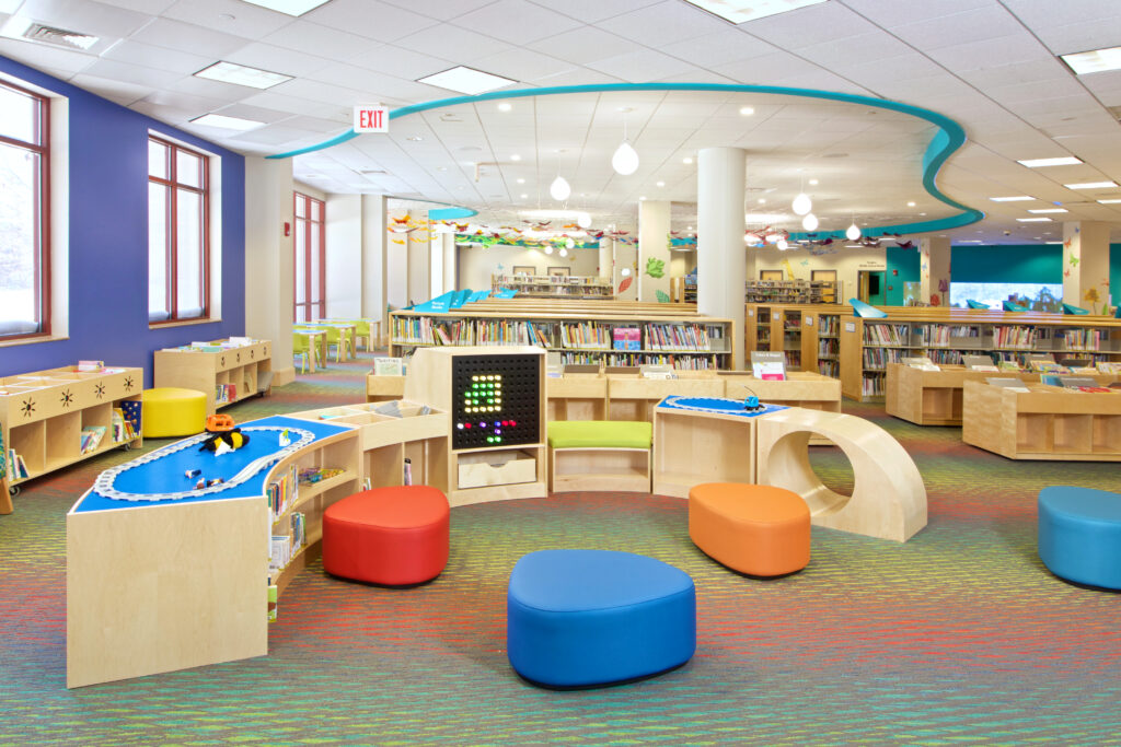 The Children's Room play area, with plenty of space to play, tucked next to the Children's book collection.