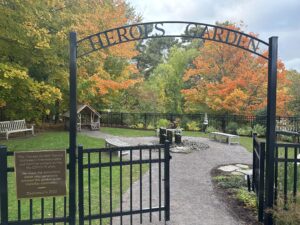 The gate to the Fells's Heroes Garden. The garden has a fountain and seating areas.