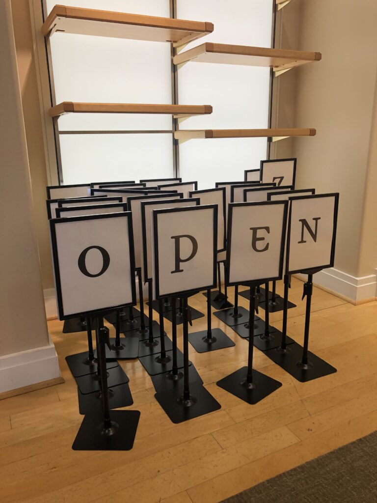 A collection of single-letter signs to organize things alphabetically arranged to say "OPEN."