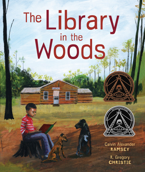 Cover of "The Library in the Woods," by Calvin Alexander Ramsey. Image description: a young boy with brown skin and curly hair in a red-striped t-shirt sits on a stump and reads a large red and green to two brown dogs. He sits in the shade across a green field from a farmhouse. The book's title is in red letter against the blue sky above the house. On the right side of the page, two black and gold and silver Coretta Scott King award medals shine.